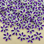 Bulk lot of purple marquise rhinestone star flower motif patches spread out on surface