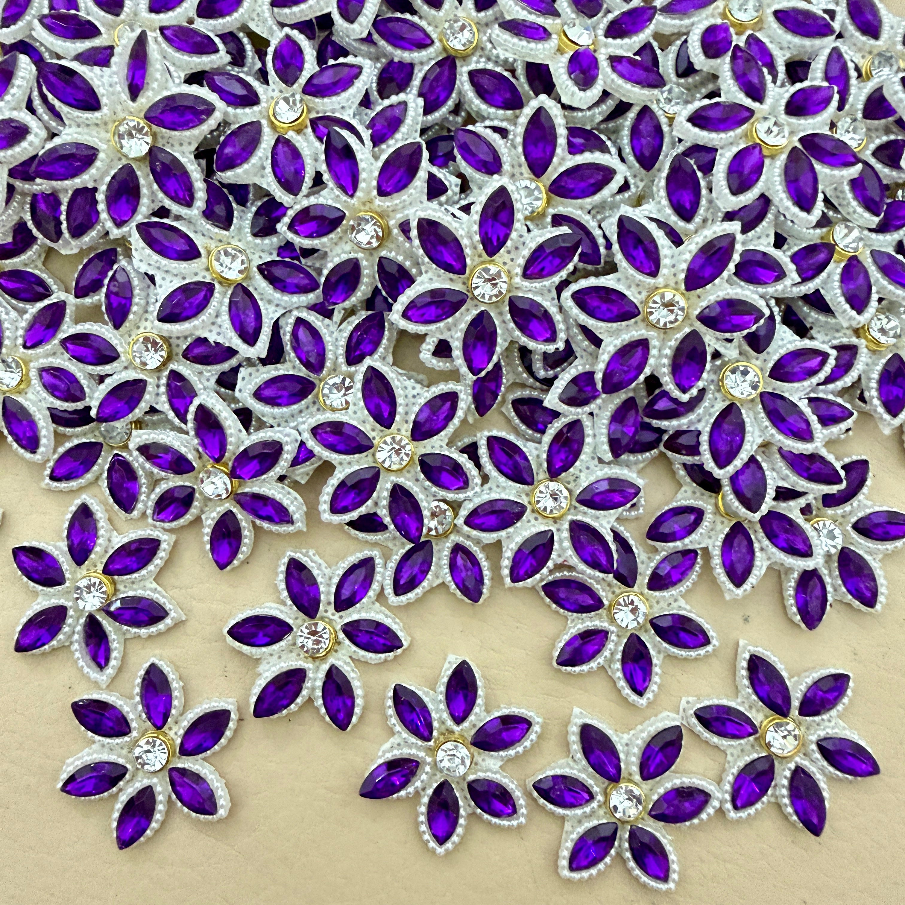 Bulk lot of purple marquise rhinestone star flower motif patches spread out on surface