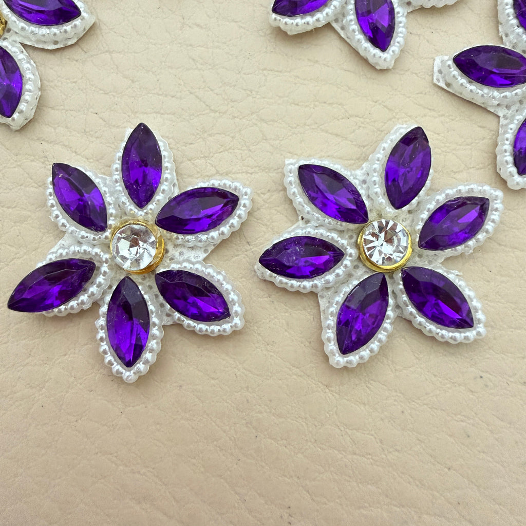 Two purple marquise rhinestone star flower motif patches showing front detail up close