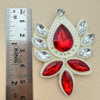 Ruby red rhinestone patch with ruler showing size approximately 6.5cm
