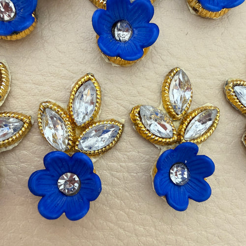 Back view of a blue flower and rhinestone leaf patch