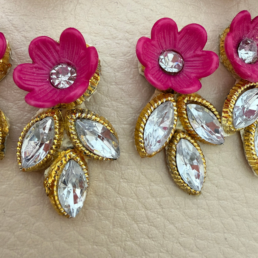 Pink flower and leaf embellishment patch held in hand to show its compact size