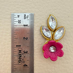 Pink flower and leaf applique patch placed beside a ruler for size reference