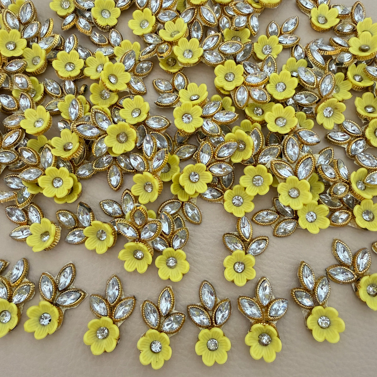 Yellow flower and leaf applique patch with clear rhinestone-style stones and gold-tone edging
