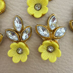 Yellow flower and leaf embellishment patch held in hand to show its compact size