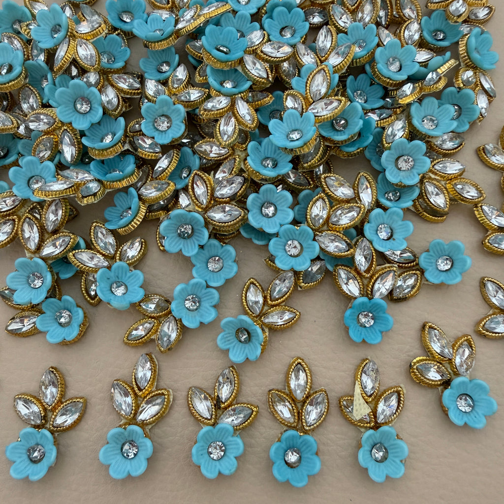 Sky blue flower and leaf applique patch with clear rhinestone-style stones and gold-tone edging
