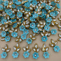 Sky blue flower and leaf applique patch with clear rhinestone-style stones and gold-tone edging