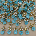 Sky blue flower and leaf applique patch with clear rhinestone-style stones and gold-tone edging