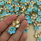 Sky blue flower and leaf applique patch placed beside a ruler for size reference