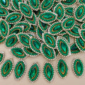 Emerald green marquise crystal patch with green beadwork, clear rhinestones, gold-tone detailing, and ivory mesh backing