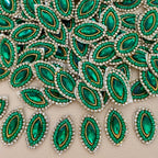 Emerald green marquise crystal patch with green beadwork, clear rhinestones, gold-tone detailing, and ivory mesh backing