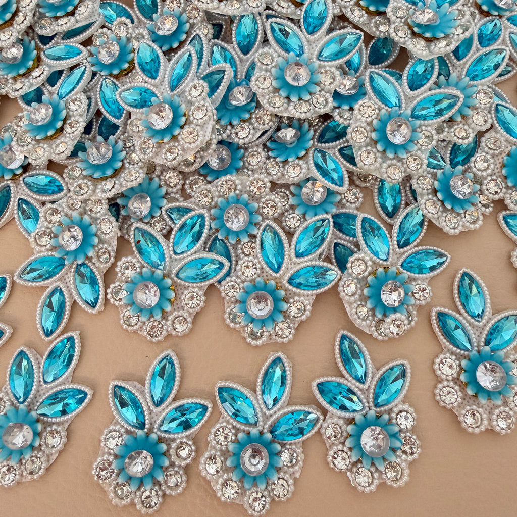 Sky blue flower applique patch with blue crystal leaves, clear rhinestones, pearl-style edging, and light fabric backing