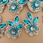 Sky blue crystal and pearl rhinestone applique patch placed beside a ruler for size reference