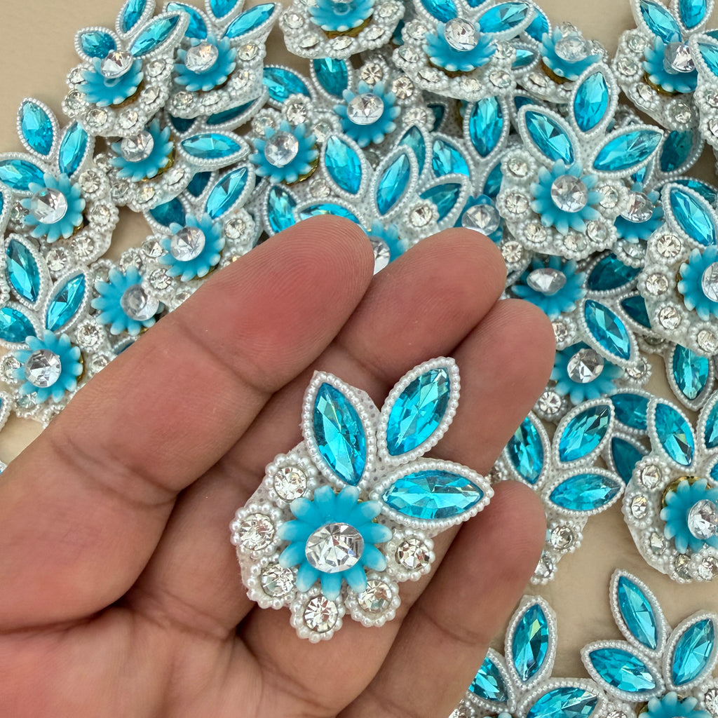 Back view of sky blue floral applique patch showing the light fabric backing