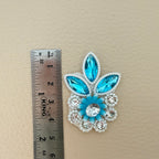 Sky blue crystal and pearl rhinestone applique patch held in hand to show its size and details
