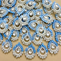 Sky blue teardrop rhinestone floral patch held in hand