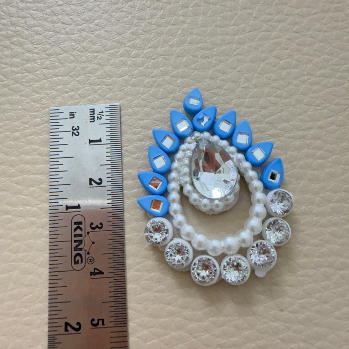 Front and white felt back of sky blue rhinestone patch