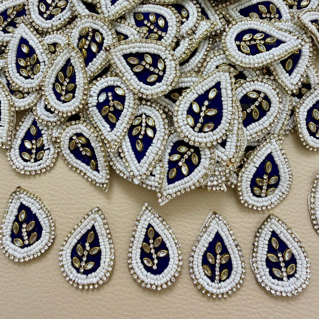 Pile of navy blue teardrop kundan floral patches with white beads