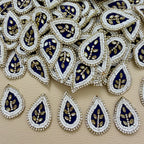 Pile of navy blue teardrop kundan floral patches with white beads