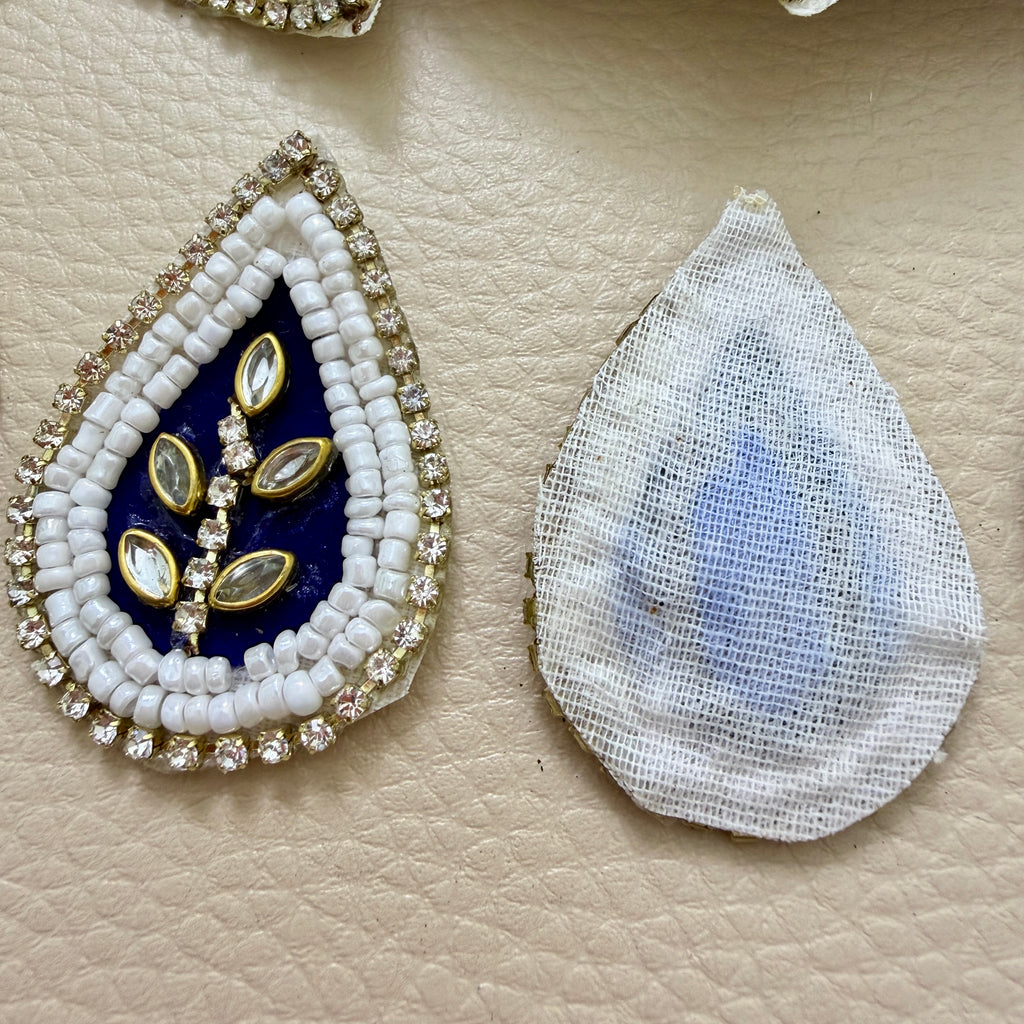 Front and white mesh back of navy blue kundan patch