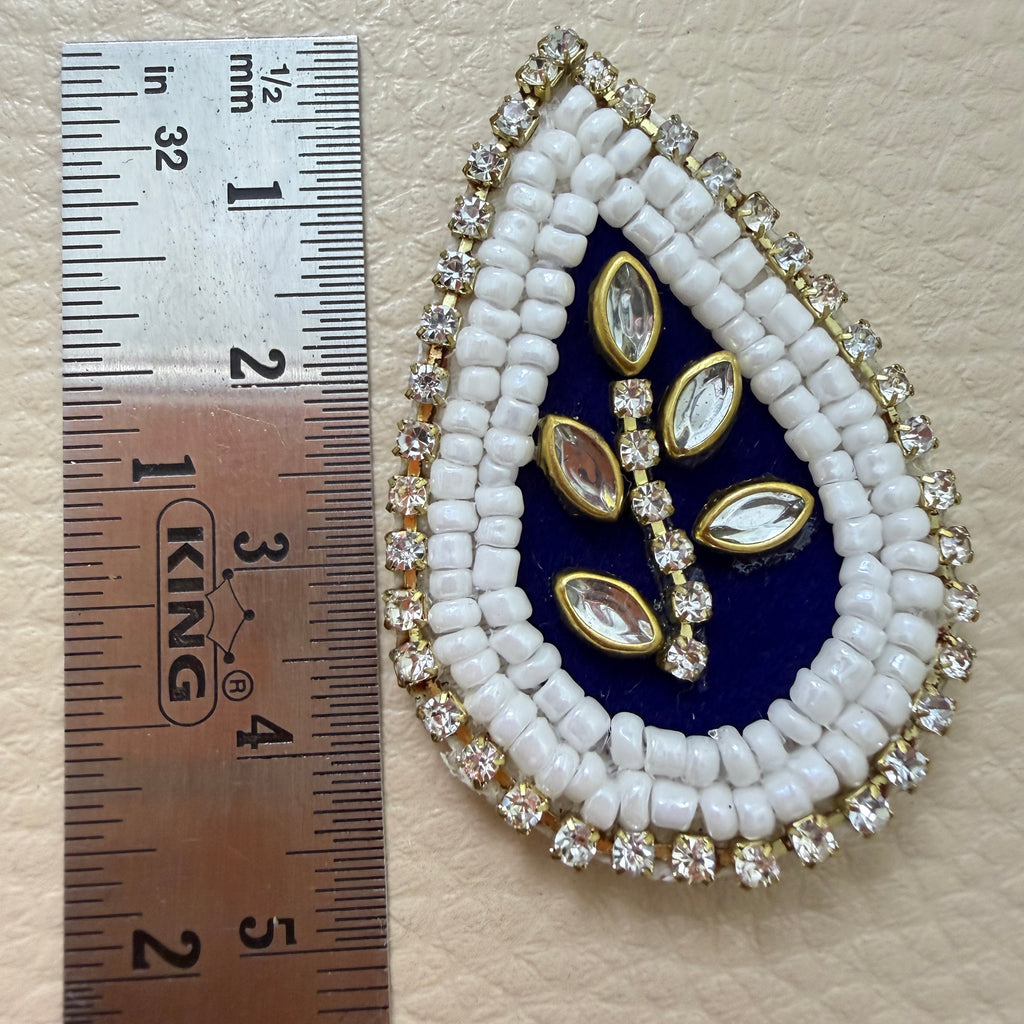 Navy blue kundan teardrop patch next to ruler showing size