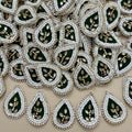 Bottle green kundan teardrop patch next to ruler showing size