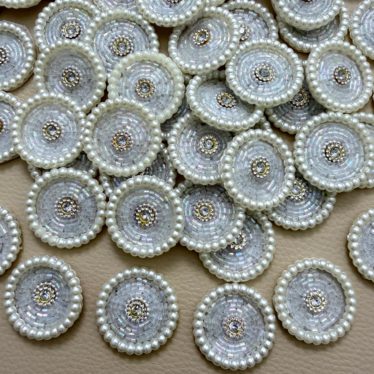Pile of white pearl bugle bead round motif patches