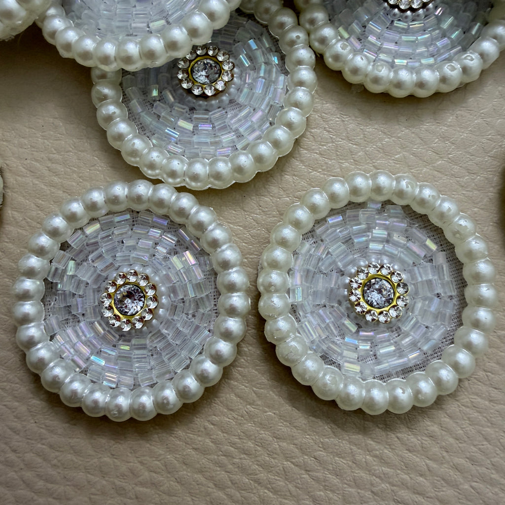 Close-up of iridescent bugle bead patches with rhinestone centre