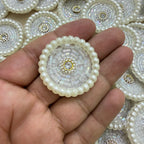 White pearl round motif patch held in hand