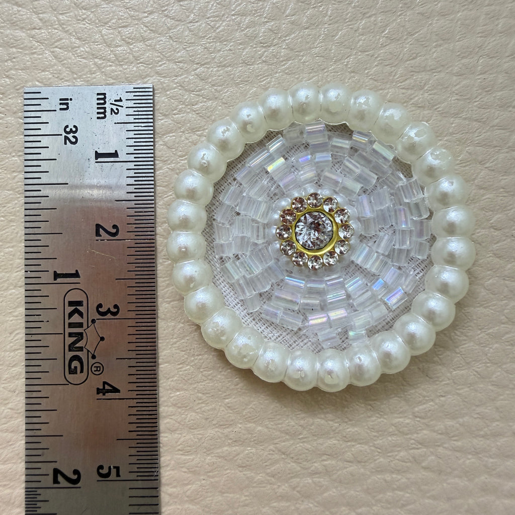 White pearl bugle bead patch next to ruler showing size