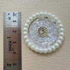 White pearl bugle bead patch next to ruler showing size