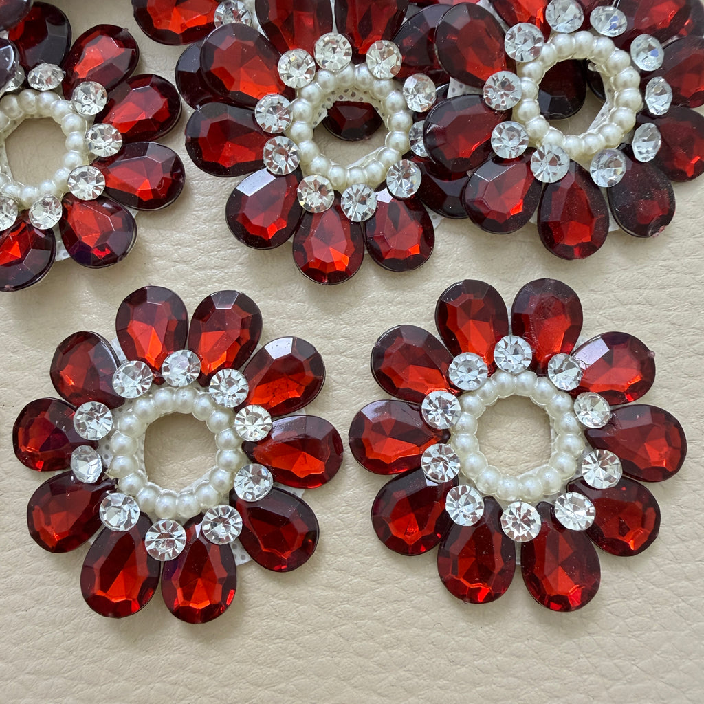 Close-up of maroon teardrop stone flower patches with pearls