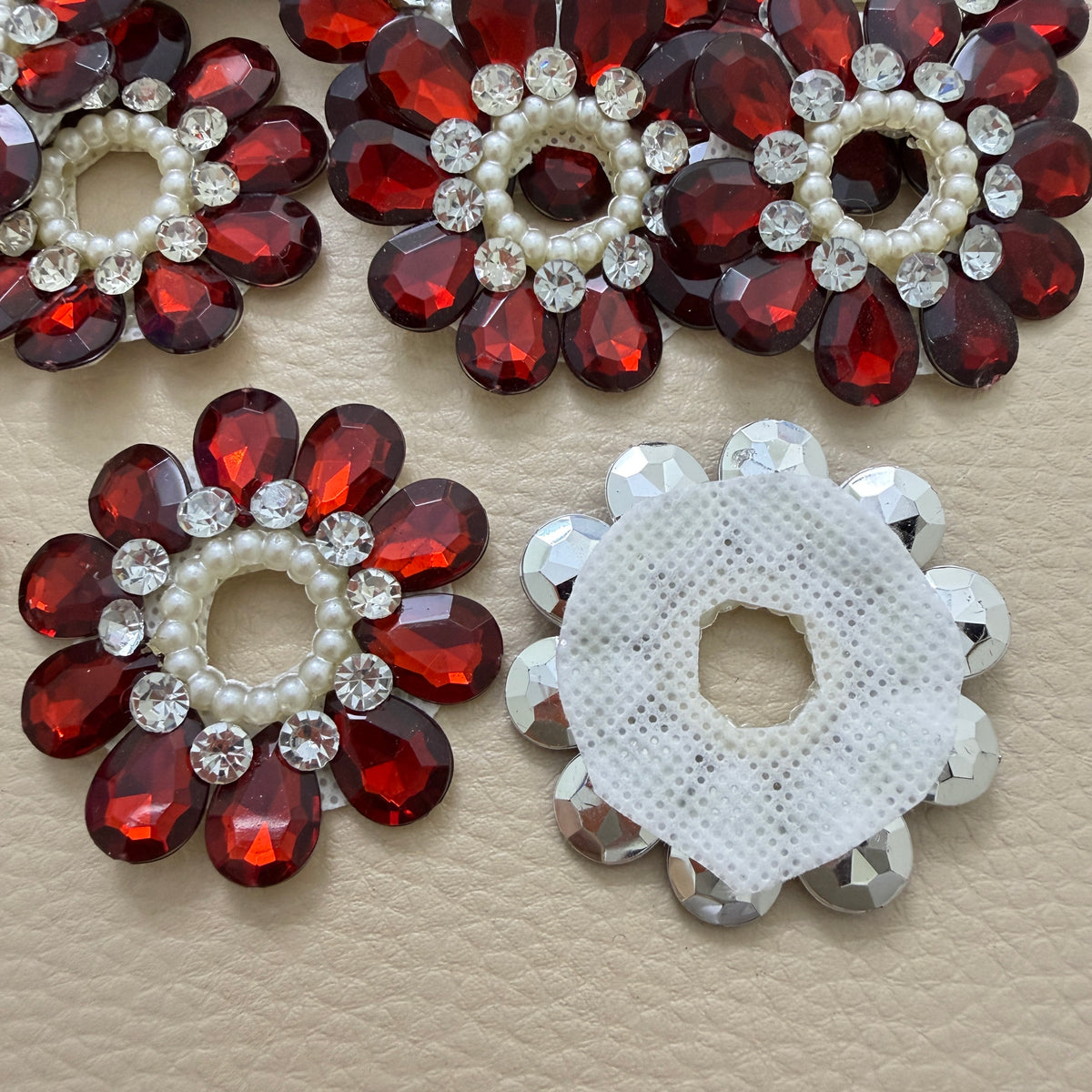 Front and white mesh back of maroon rhinestone flower patch