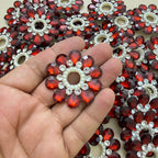 Maroon rhinestone flower patch held in hand