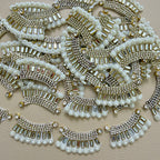 Antique gold-tone rhinestone and pearl crescent motif patches close-up
