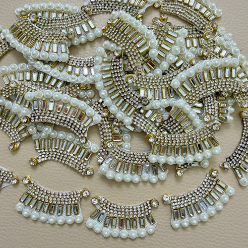 Antique gold-tone rhinestone and pearl crescent motif patches close-up