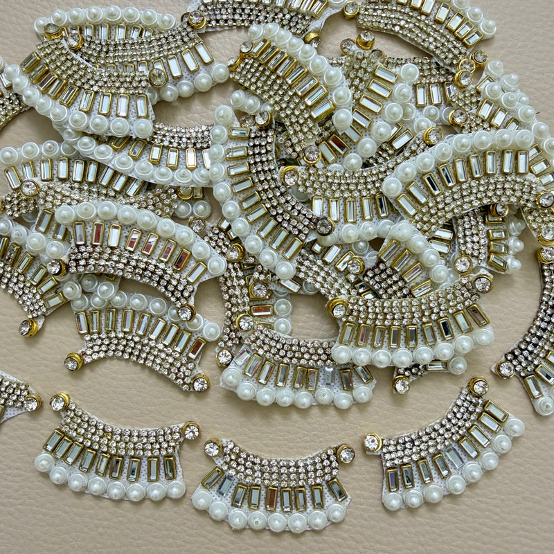 Antique gold-tone rhinestone and pearl crescent motif patches close-up