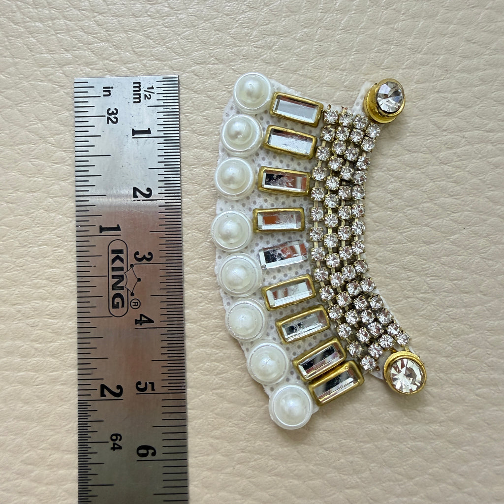 Front and white mesh backing of rhinestone pearl crescent patches