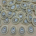 Pearl and rhinestone teardrop patch front beside white mesh backing