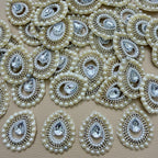 Pearl and rhinestone teardrop patch front beside white mesh backing