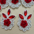 Front and white mesh backing of a red rose rhinestone patch