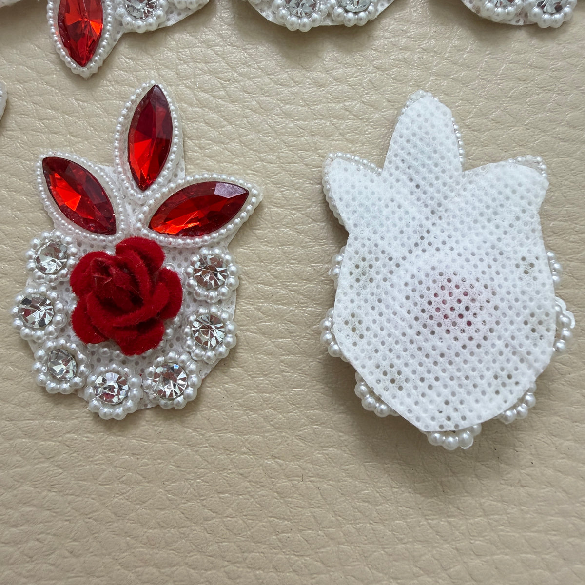 Red rose rhinestone flower patches shown together in a craft supply pack