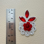 Red rose rhinestone patch beside a ruler for size reference
