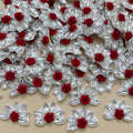 Maroon velvet rose rhinestone flower motif patch held in hand showing size
