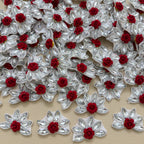Maroon velvet rose rhinestone flower motif patch held in hand showing size