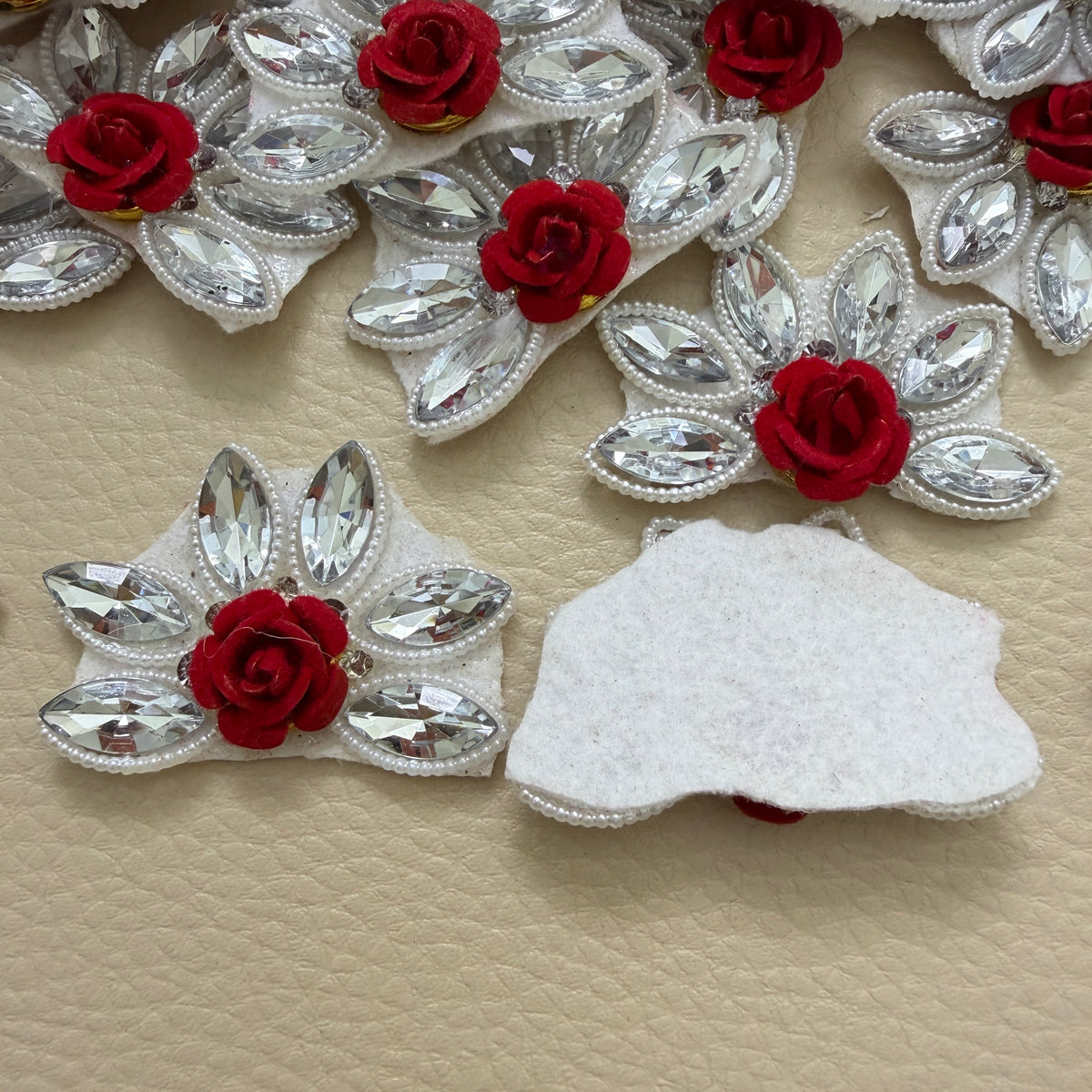 Maroon rose rhinestone flower motif patch beside a ruler showing approx 3.5 cm by 3 cm size