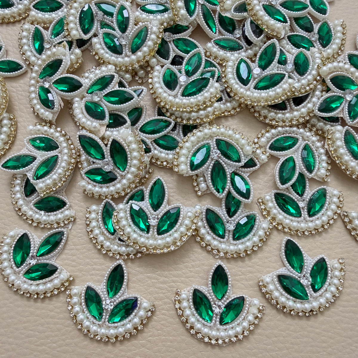 Green leaf motif patch beside a ruler for size reference