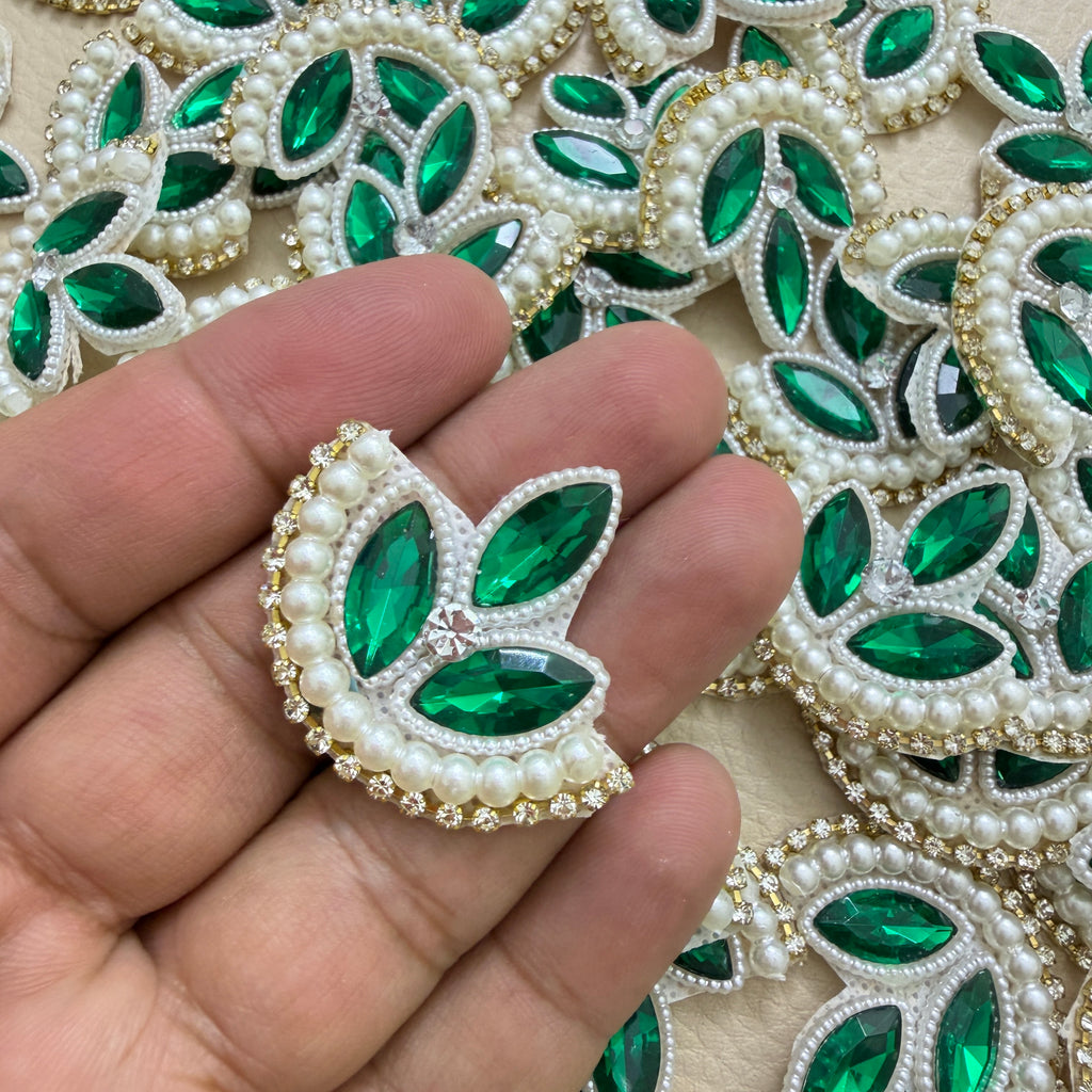 Green embellished leaf patch held in a hand for scale