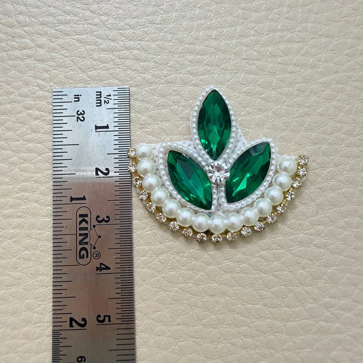 Front and white backing of emerald green leaf applique patch