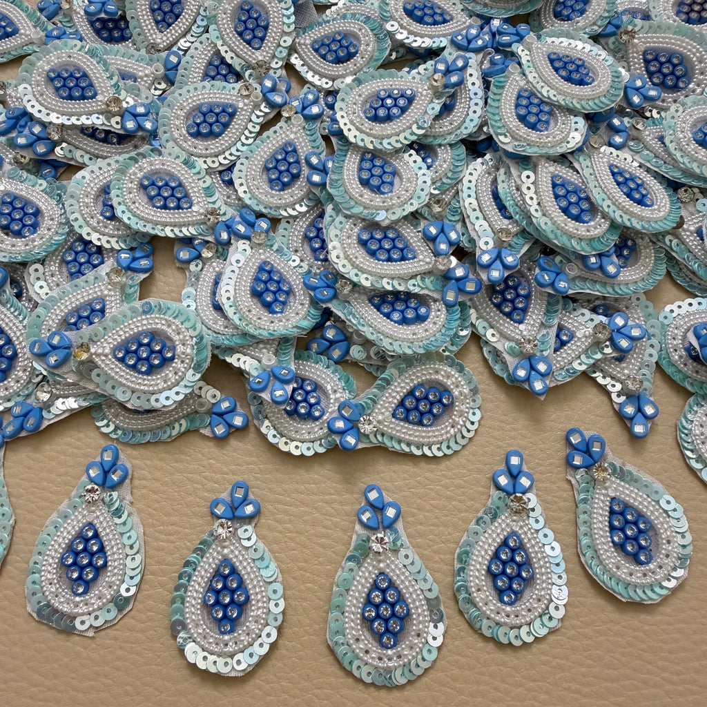 Front and white mesh backing of blue pearl and sequin teardrop patch